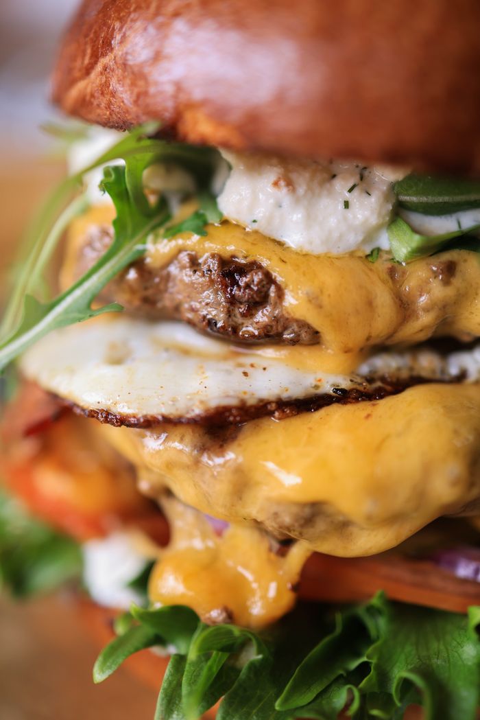 Mouth-watering cheeseburger with fresh toppings, perfect for food photography lovers.